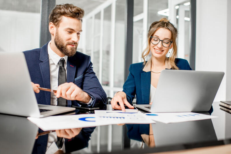 Business accounting professionals reviewing financial charts and reports